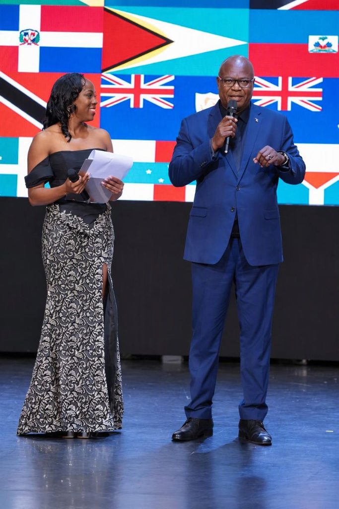 Hostess Samara with SVG High Commissioner Brereton Holm as he delivered the welcome speech